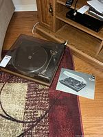 Turntable and manual on floor showing overall lot
