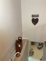 Overall view of paper bin and two tabletop plaques; hanging “SIMPLIFY” sign visible