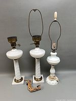 All three milk glass lamps front view showing relative sizes, bases, harps and cords