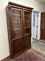 Front view showing full cabinet, glass upper doors and wood lower doors