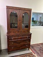 Front view of entire two-piece hutch showing upper glass cabinet and lower drawers