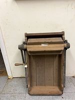 Full view of wooden butter worker showing rollers, tray, and crank handle