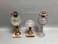 Full view of all three glass whale oil lamps