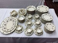 Full set laid out showing plates, bowls, serving pieces