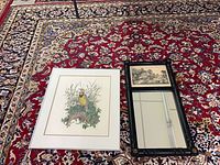 Bird print and mirror side by side on rug