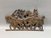 Full view of brass plaque showing three riders on horseback