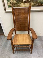 full front view of wooden high back armchair with woven cane
