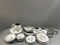 Full set laid out showing plates, bowls, serving pieces