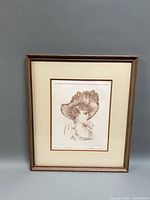 Full view of framed etching showing frame, mat and image