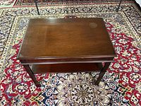 Top view of wooden end table on patterned rug