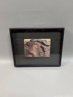 Front view of framed embroidery artwork