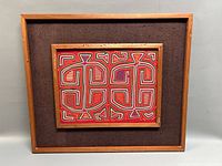 Full view of framed Mola art showing frame and mat