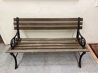 Full front view of cast iron and wood bench