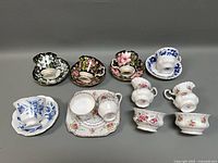 Full collection showing all cups, saucers, creamer and plate