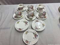 Complete set laid out showing all cups, saucers and plates
