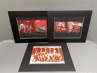 Three matted Tom Durham lithographs displayed