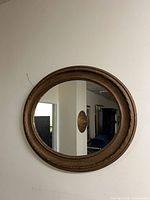 Full view of oval mirror on wall
