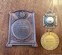 Front of all three awards showing designs and text