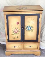 Front view showing floral doors and two drawers