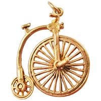 Front view of 9K gold penny-farthing bicycle charm showing spoke detail, small rear wheel, seat, handlebars and bale