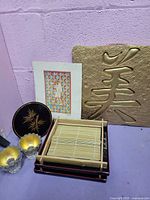 Group shot showing plaque, trays, bamboo mat, votive holders, and print