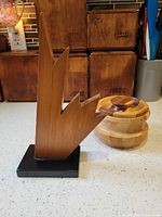 Sculpture and lidded jar together on countertop