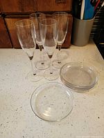 Group shot of 4 flutes and 5 glass plates