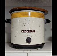 Front view of Rival Crock-Pot showing branding, dial, exterior finish, and lid