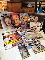 Full lot overview showing magazines, posters, cards and coin