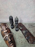 Group shot of two masks and two busts