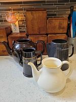 Group shot of all four teapots showing colors and finishes
