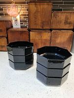 Two stacks of three black octagonal bowls showing shape and stackability