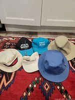All six hats laid out showing overall styles and colours