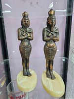 Front view of both bronze pharaoh figurines on onyx bases