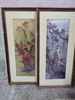 Both framed Asian-themed prints side by side