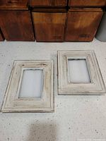 Front view of both distressed white wood frames