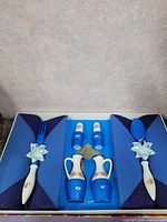 Complete set in box showing all six items fitted in blue insert