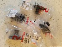 Overview of four packaged Richelieu brackets plus one partially visible