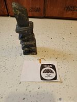 Entire sculpture standing with tag visible