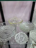 Group shot showing all clear glass pieces on shelf