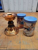 Candlestick with two tin shakers front view