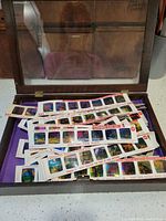 Open wooden box showing purple liner and multiple Disney film strips