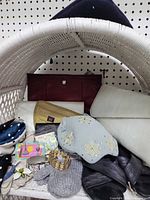 Overview of lot inside white basket; visible clutches, hats, mittens, gloves, jewellery