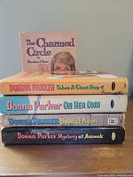 Stack of five Whitman paperback books showing spines and one cover