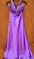 Full view of lilac satin floor-length prom dress on hanger