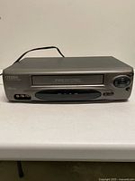 Front angled view of Citizen JVHS3975 VCR showing overall condition, controls and attached power cord