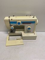 Front view of Mason sewing machine with extension table removed