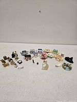 All items laid out showing quantity and variety of figurines and teapots