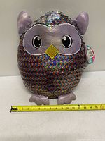 Front view showing rainbow side with measuring tape