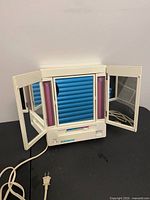 Front view of Windmere EM-6 mirror with side panels open showing mirrors and light tubes